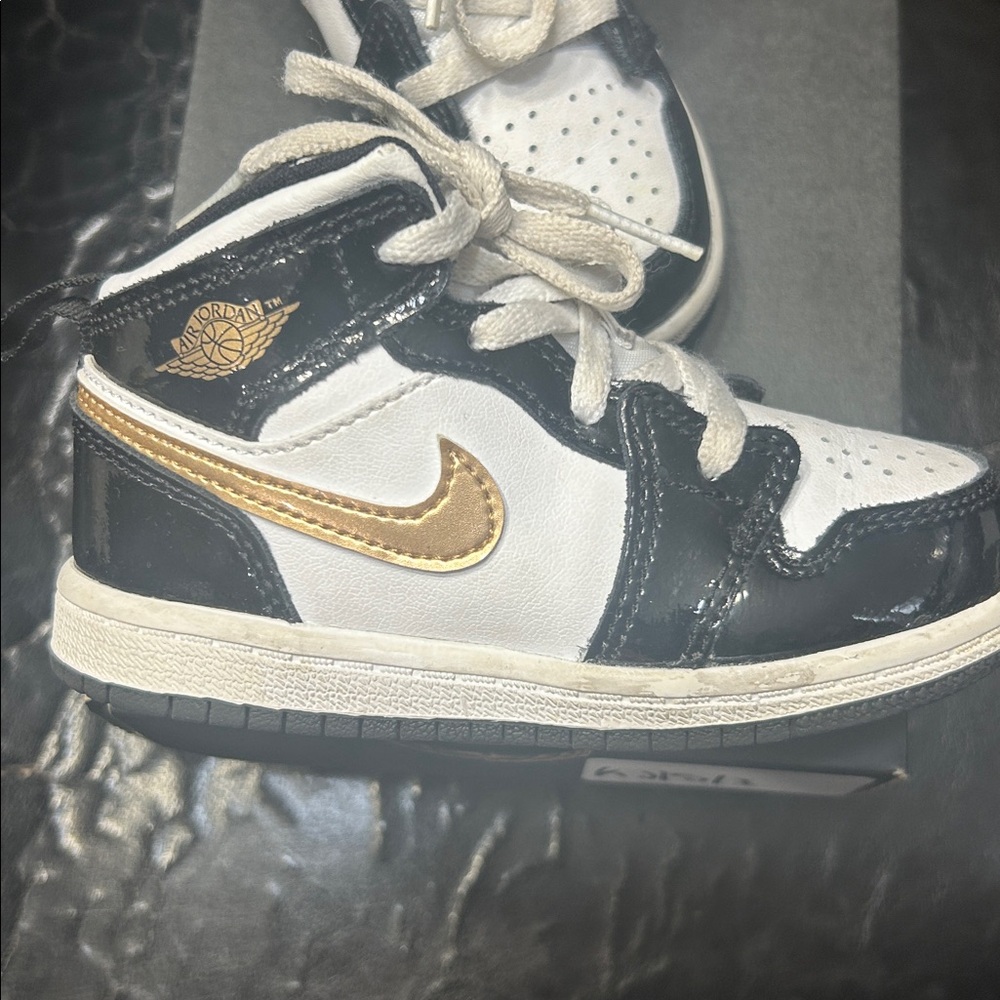 Nike Air Jordan 1 Black and White Sneakers with Gold Swoosh